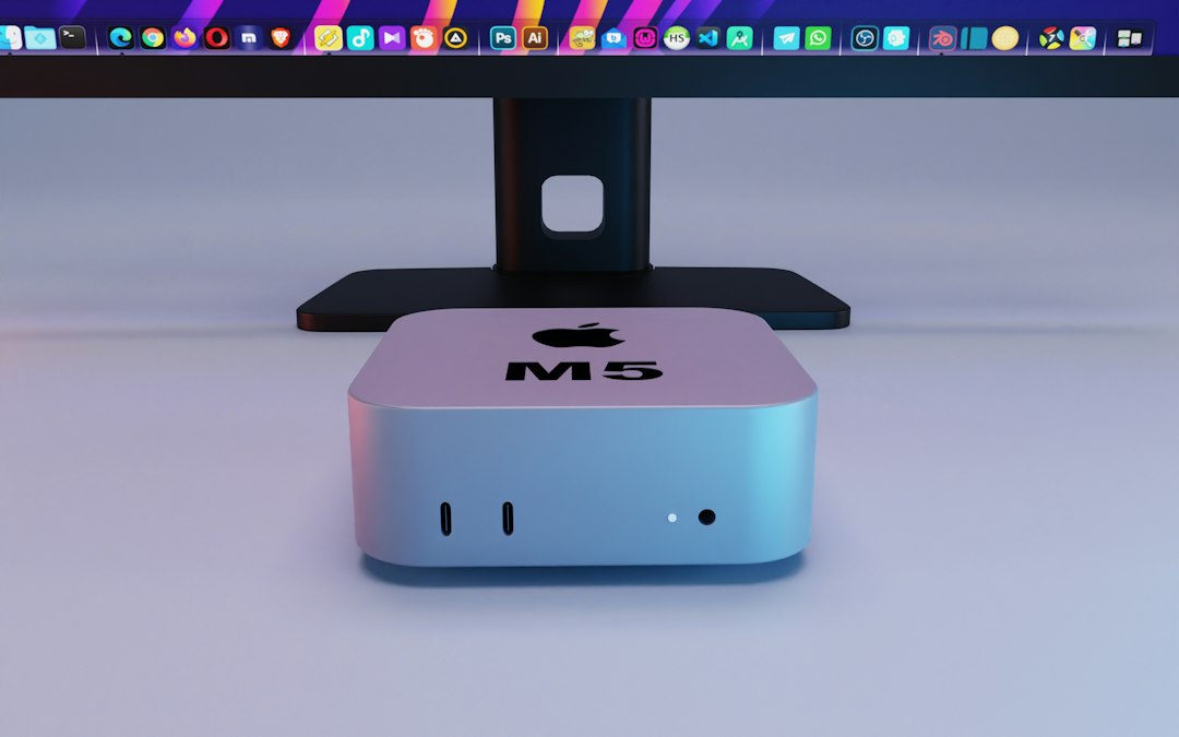Small aluminum desktop computer sitting under a monitor