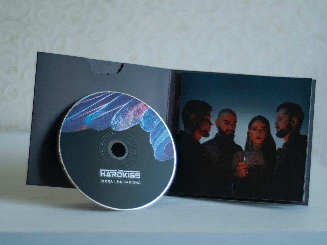 An open CD jewel case with the disc resting beside it