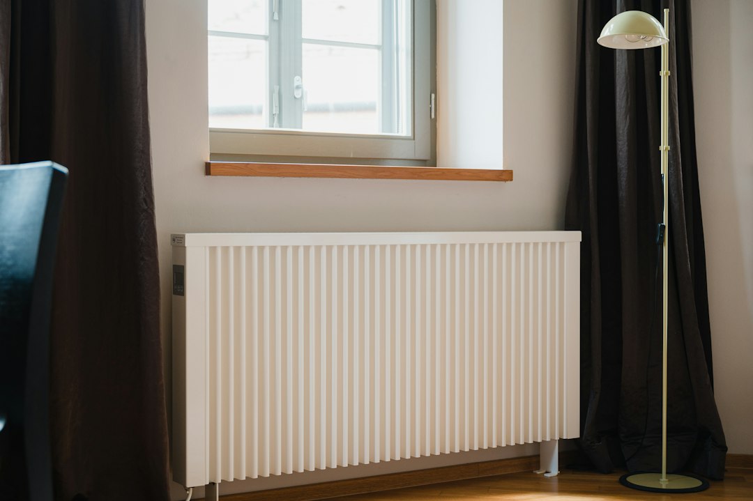 A panel radiator under a window, the kind of heat that lives in the room instead of down the hall.