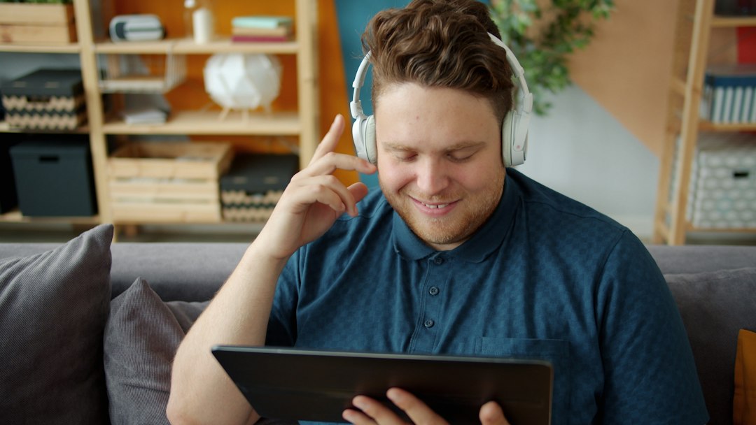 A person watching video on a tablet from the couch