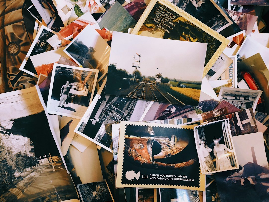 Scattered printed family photographs spread across a table