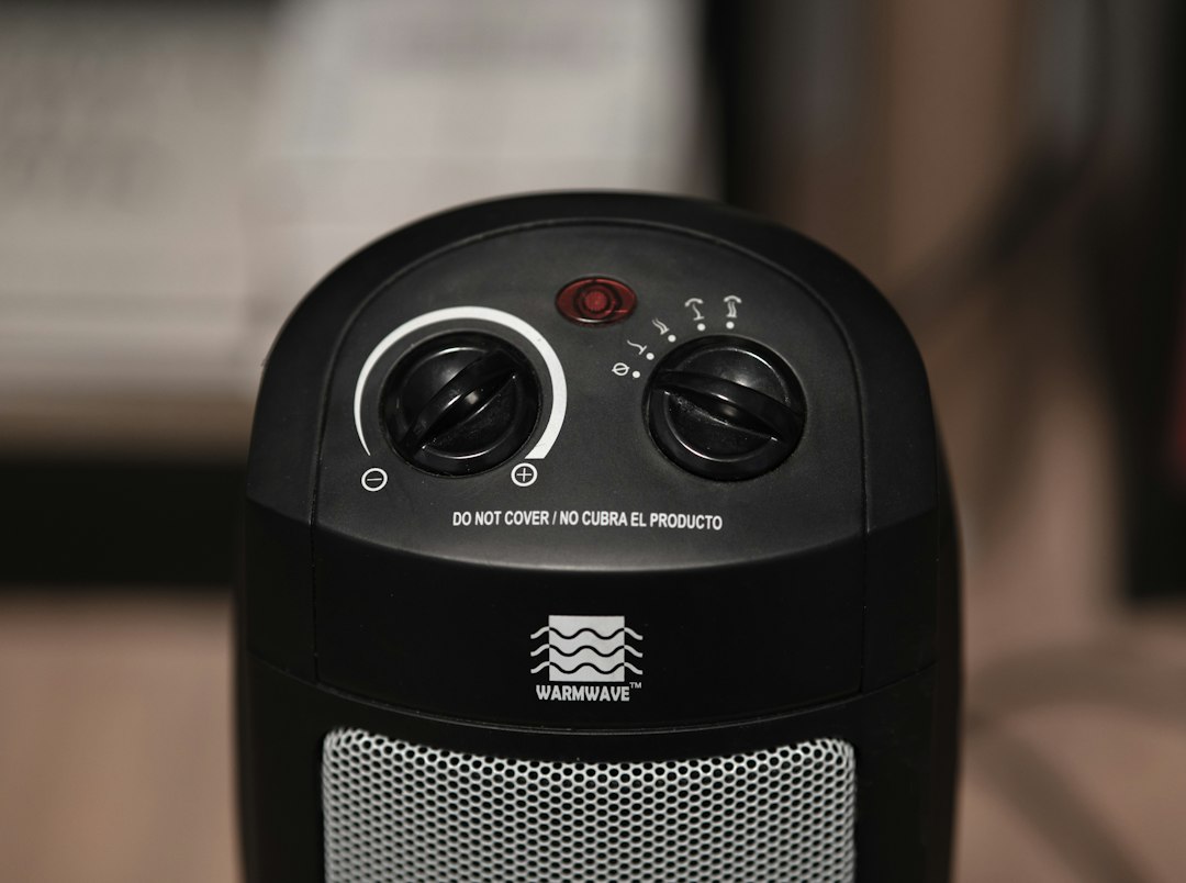 The controls on a personal space heater, including a do-not-cover warning. This is the product class, not a specific model I am telling you to buy.