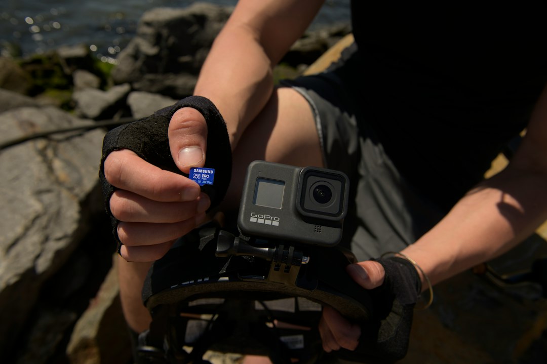 Loading a microSD card into an action camera outdoors