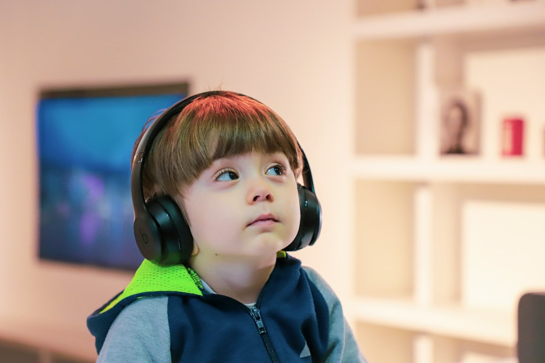 A child wearing over-ear headphones in a living room