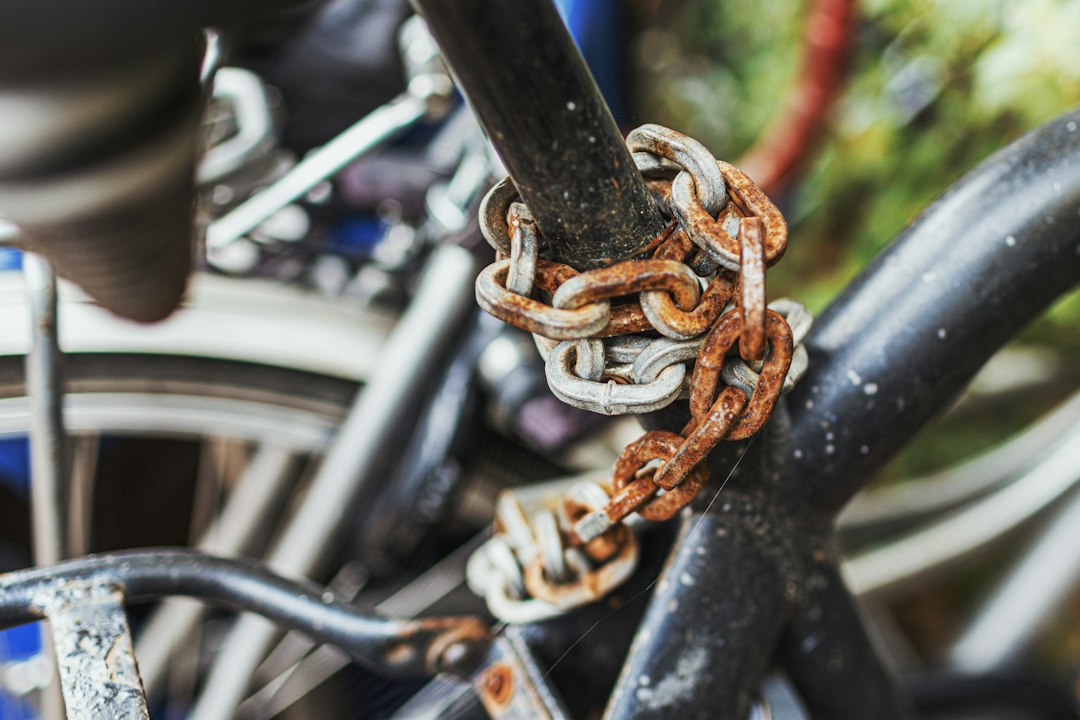 Weathered chain lock wrapped around a bicycle frame