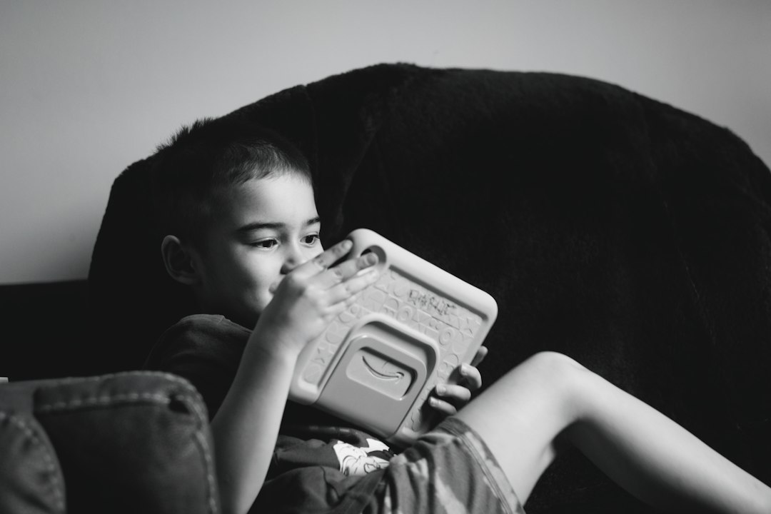 A child using a tablet with a colorful protective case