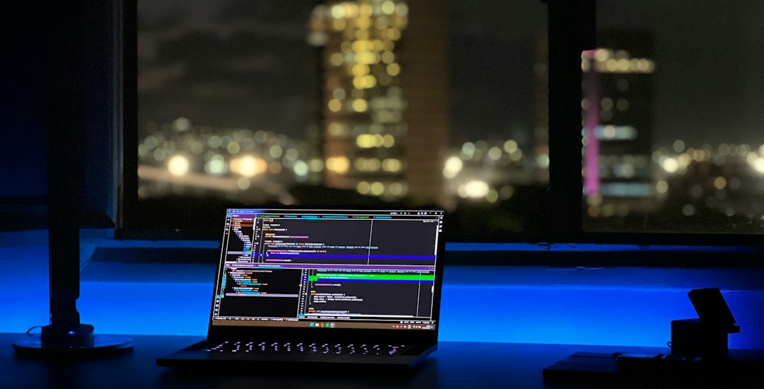 A laptop running code on a dark desk at night, the kind of late tuning session that separates a fast local AI box from a slow one
