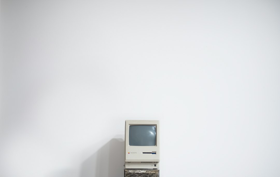 A vintage beige Macintosh computer on a white surface