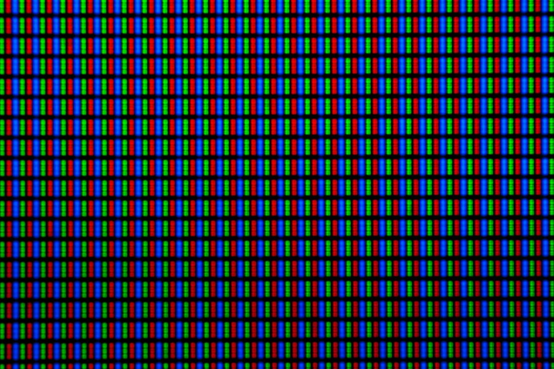 Extreme macro shot of an LCD screen showing red green and blue subpixels in a grid