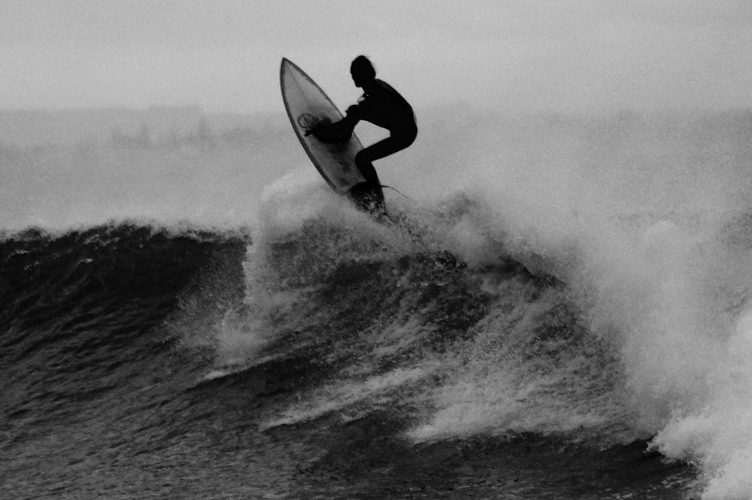 Surfer riding a wave in dramatic silhouette