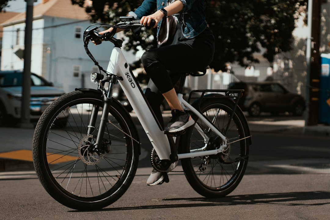 Rider commuting through city traffic on a white electric bike