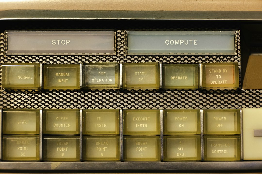 A vintage computing control panel with backlit operation buttons