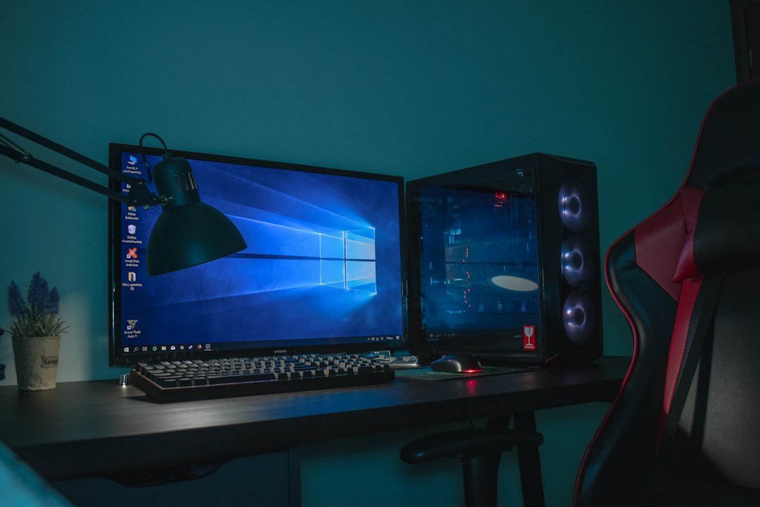 Desktop gaming tower with a lit case beside a monitor