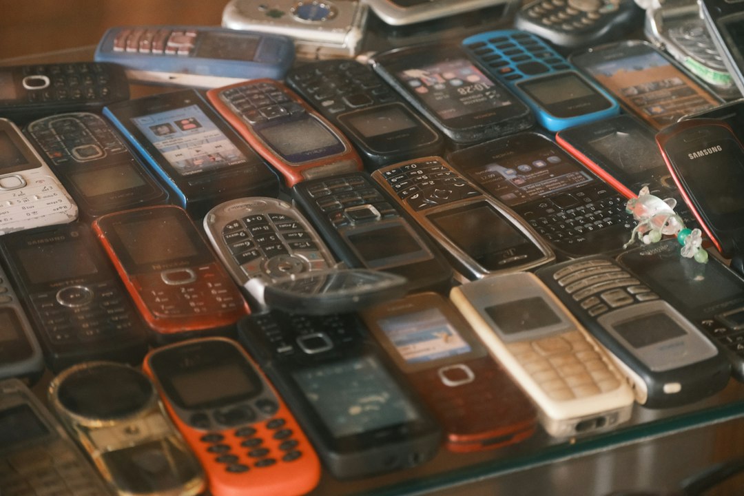 A display table crowded with dozens of old keypad and flip mobile phones in every color, a reminder of how many basic phones came before the current models