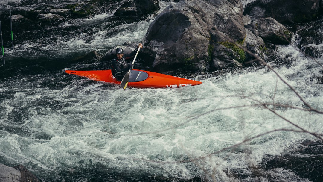 Kayaker paddling through whitewater rapids